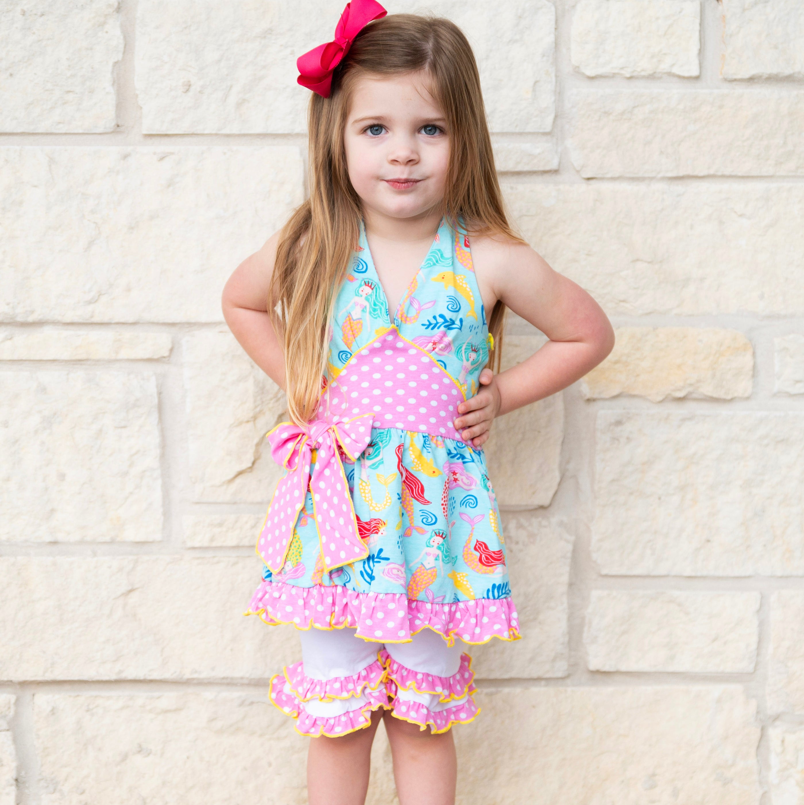 AnnLoren Girls Mermaid Halter Dress featuring a pink polka dot waistband and big bow, paired with white ruffle shorts, perfect for summer wear.